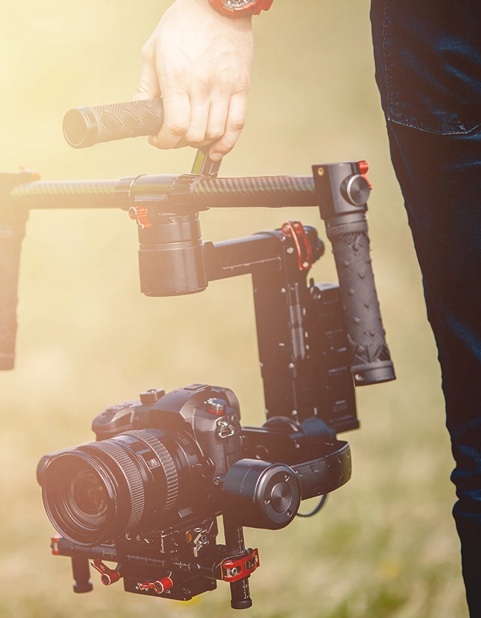 Videographer holding camera with gimbal stabilizer