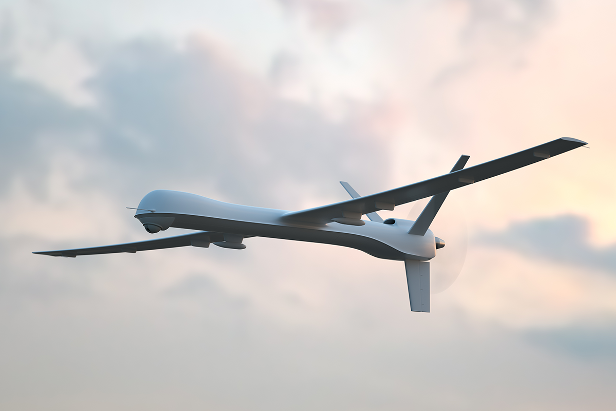Military drone flying in sky